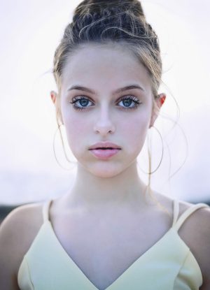 Daughter Beautiful portrait of a girl with big hoop earrings on and her hair up, looking into the camera in McKinney TX.