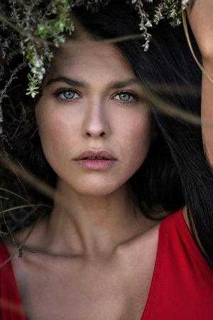 Wild Flower Model Portrait of a woman with dark hair and green eyes.