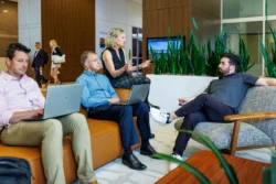 Casual business meeting with four executives in building lobby