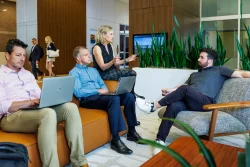 Casual business meeting with four executives in building lobby